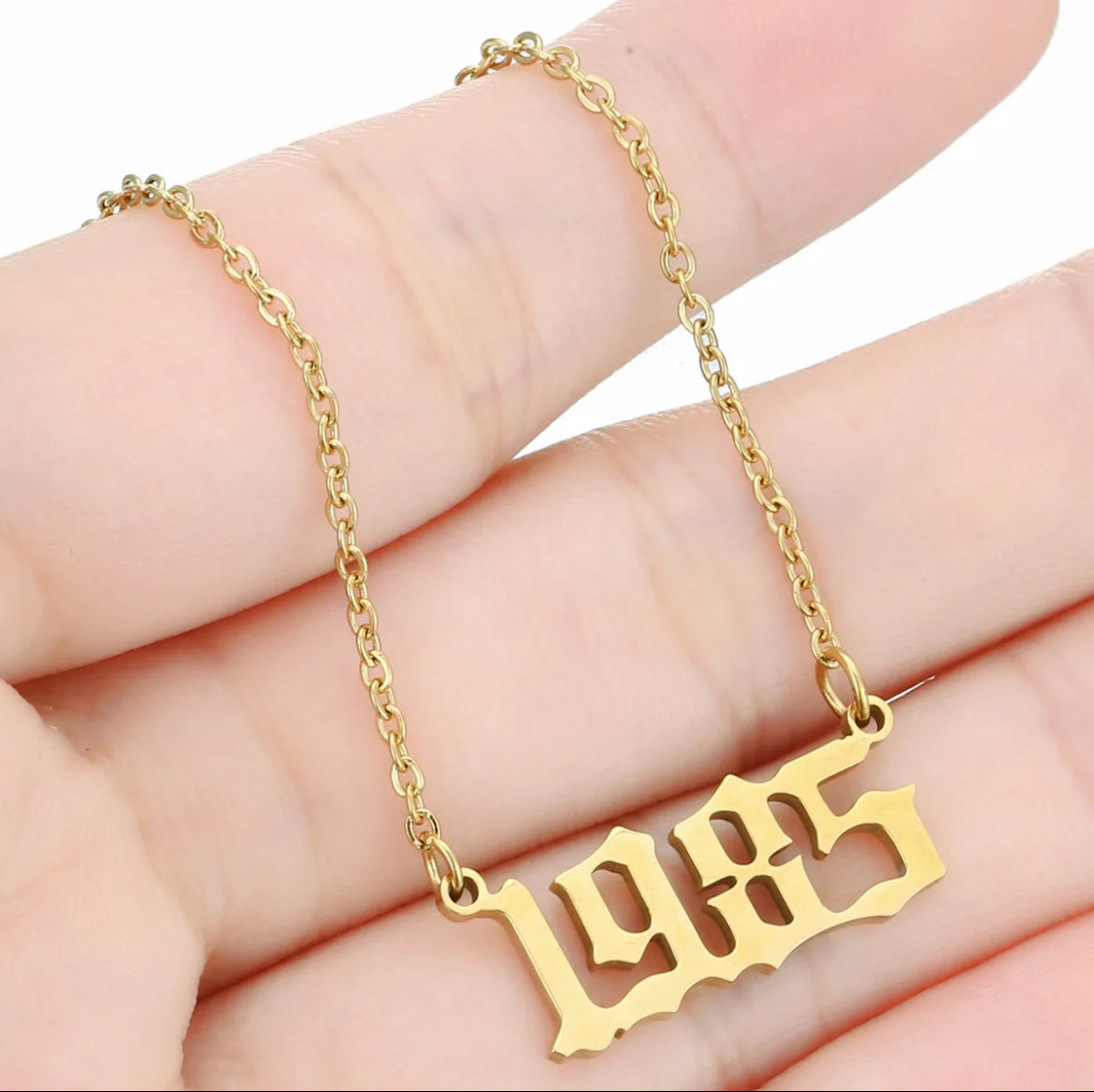 Birth year necklace. ￼￼ Stainless steel, 18 karat gold plated.